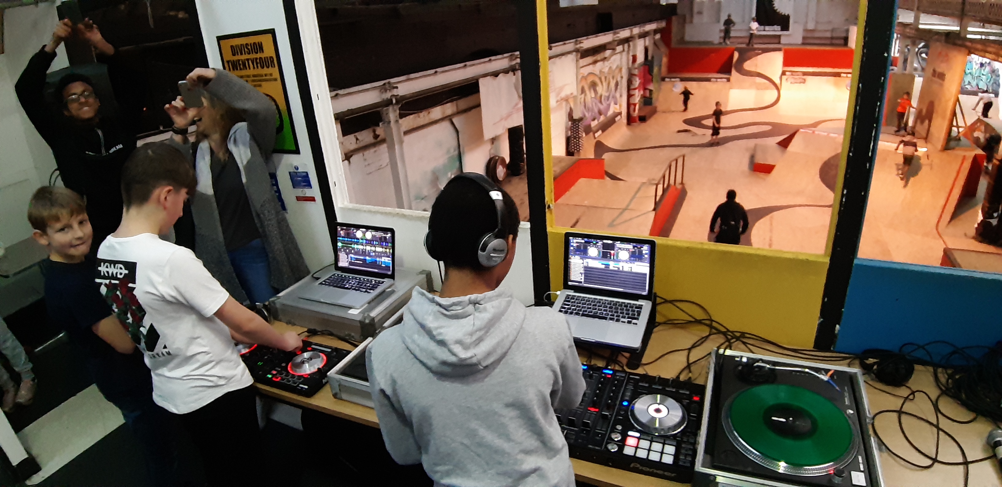 young boys learn how to use DJ decks