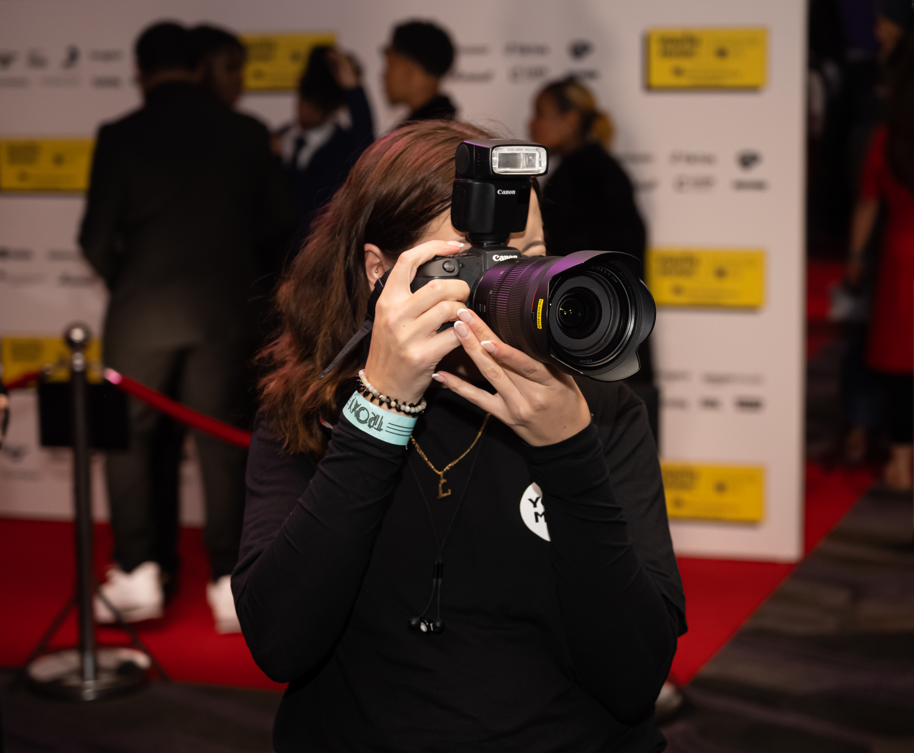 a photographer takes a photo at the youth music awards