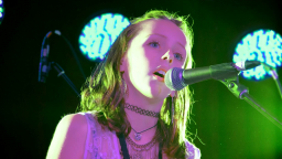 Young musician singing into microphone