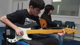 Mike playing a bass guitar