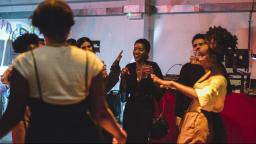 Group of people dancing and holding drinks