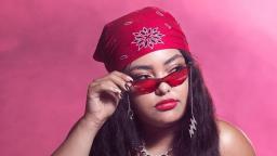 chante amour wears red sunglasses and a patterned headscarf. She looks away from the camera.