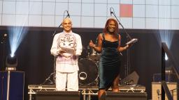 ben greenstein and nieema stand on stage and present the youth music awards 2022