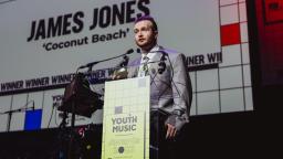 james jones accepts his award on stage