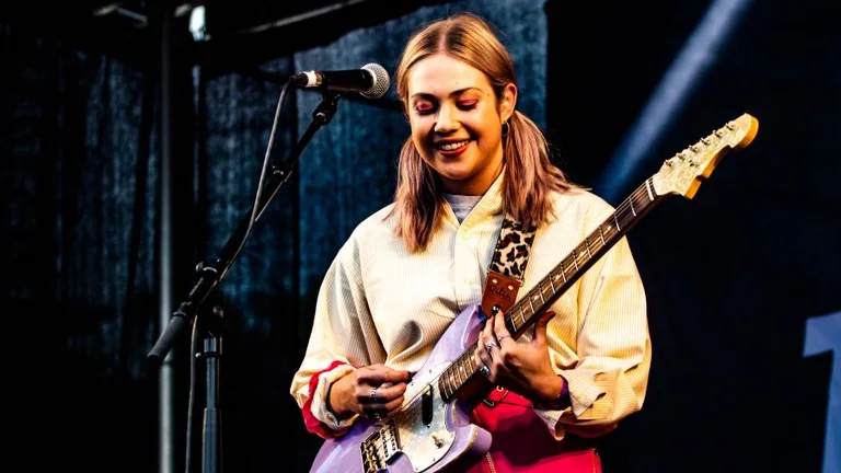 young person playing guitar