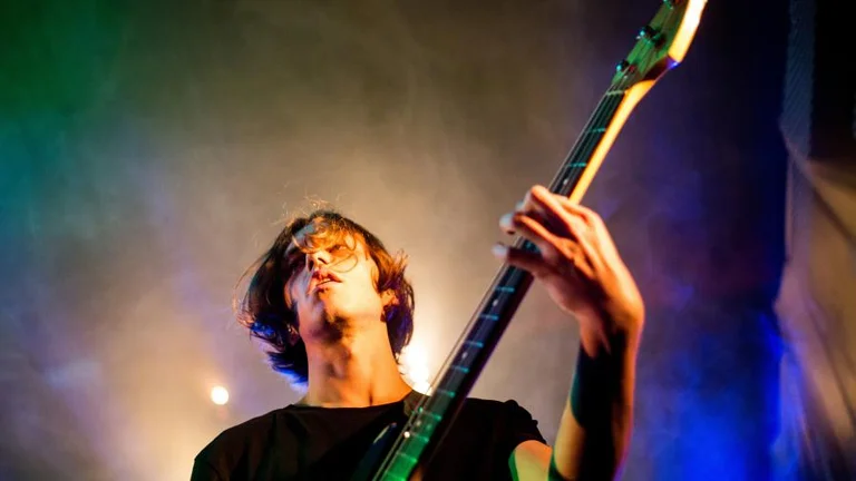 young person playing guitar