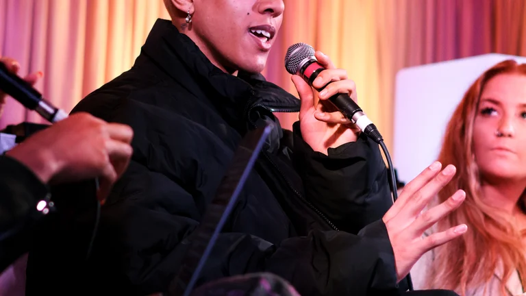 a person speaks into a mic on a panel