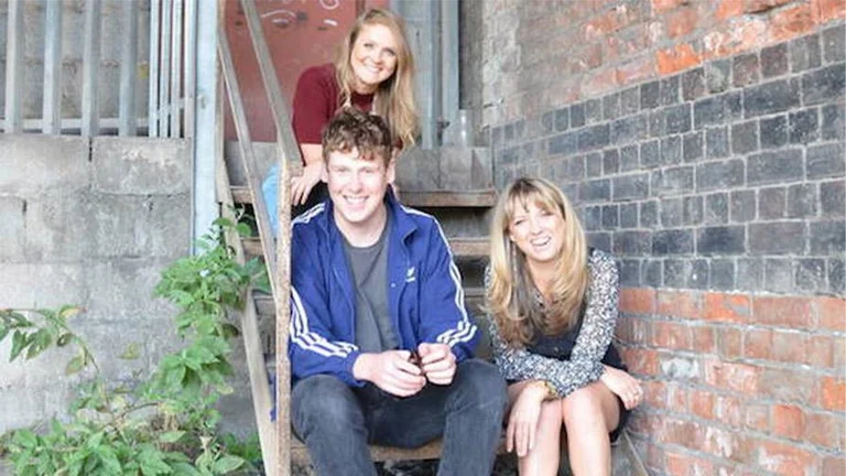 three people sitting in stairs