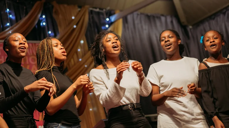 Five young people singing in a Christmas event