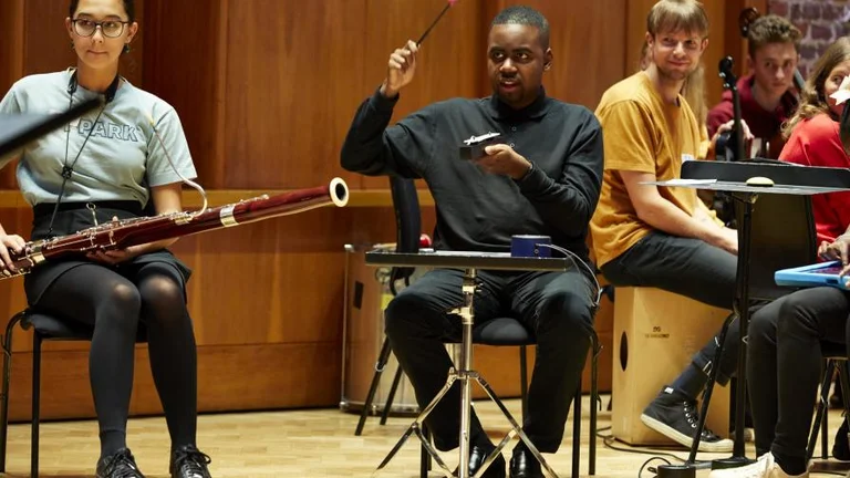 Young people playing orchestral instruments 