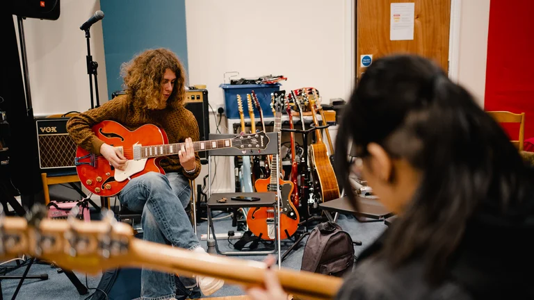 Young people learning the guitar