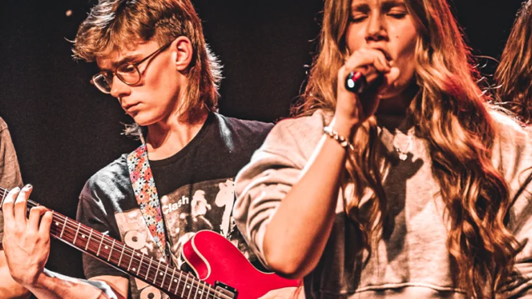 Young people playing music on stage