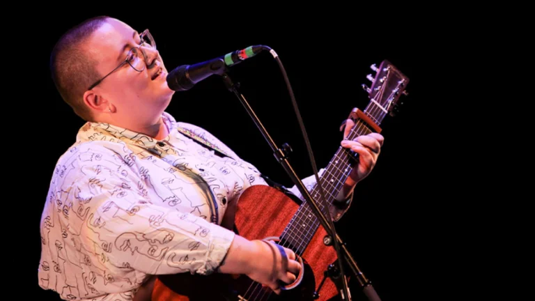 maddie morris playing a guitar and singing