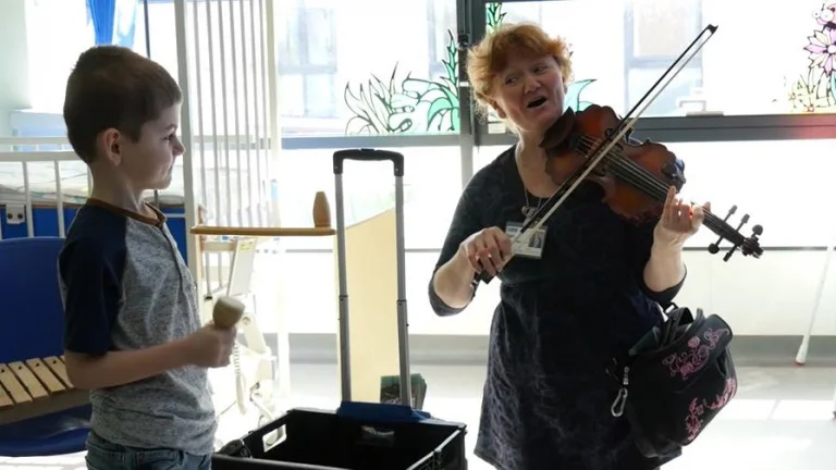 sarah singing with boy playing shaker