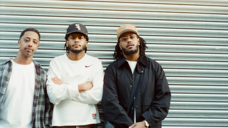 three men pose together