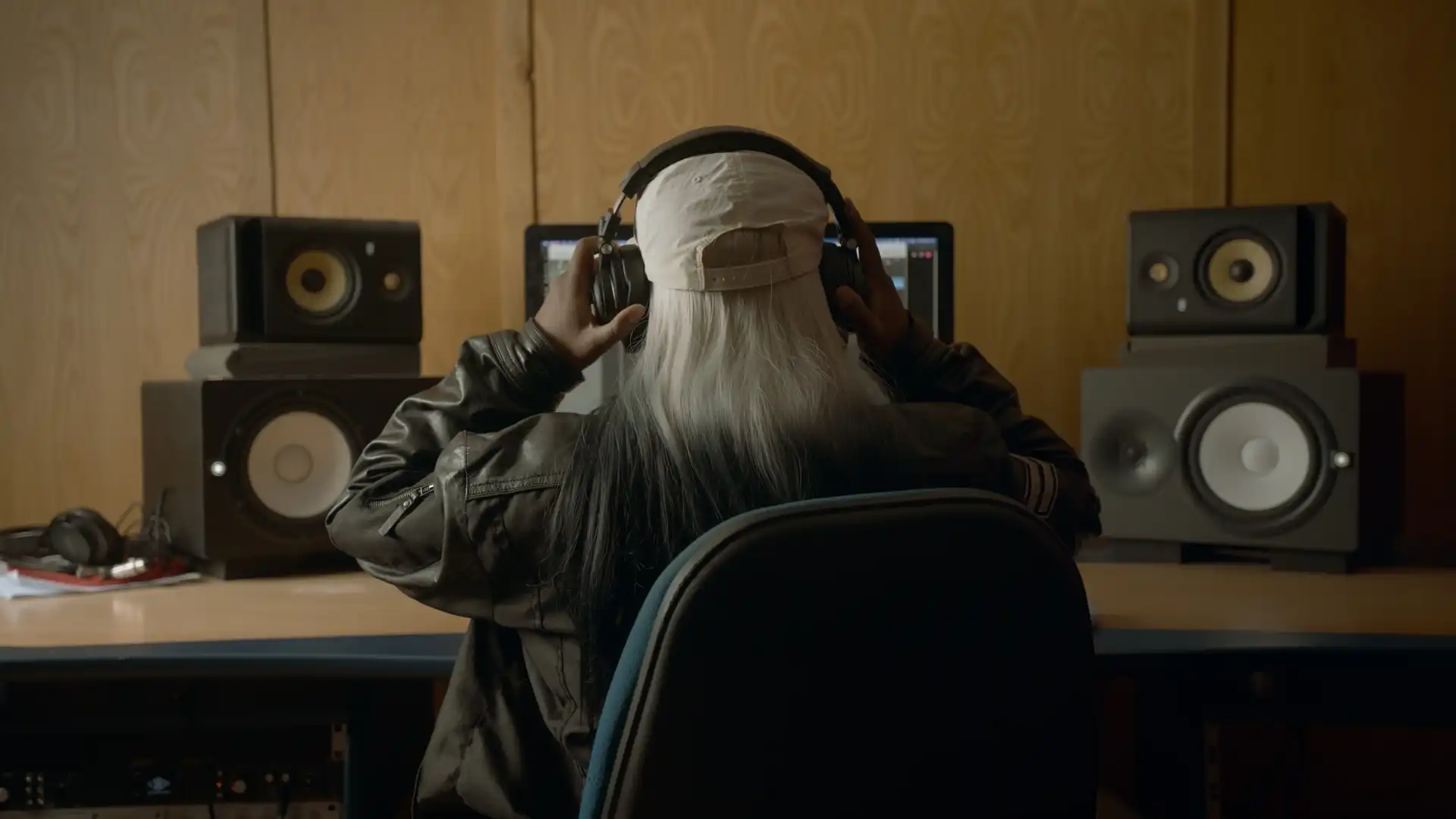 Girl with headphones at mixing desk