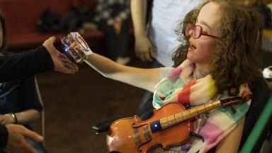 Disabled girl playing a violin