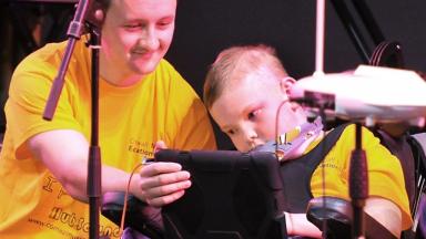 music leader helping a young person make music