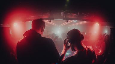 Image of electronic duo Bicep performing at Stealth Nightclub. The image is shot from behind them.