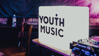 a white light up box with the youth music logo in black branded across the front