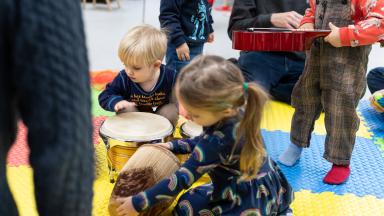 toddlers play with musical instruments