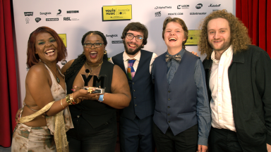 a group of people hold their award