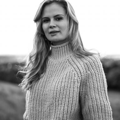 Black and white photo of Eve outside wearing knitted jumper