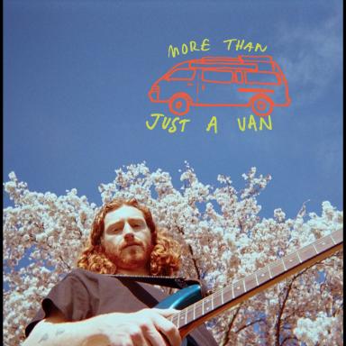George Bloomfield holding a guitar against a backdrop of blue sky and cherry blossom trees