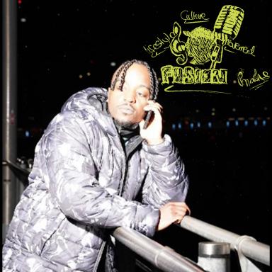 Panashe wearing a puffa jacket and leaning on metal railing, resting his head on his hand