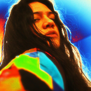 a person with long brown hair is pictured in technicolour