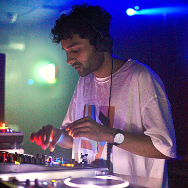 michael diamond DJs in a white t-shirt