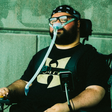 supermann on da beat sits in a wheelchair and wears a wu tang clan t shirt