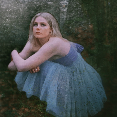 blades wears a blue tulle dress and has blonde hair