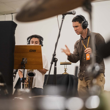 a man instructs a child musician